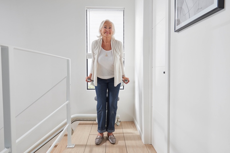 flow x curve stair lift with woman getting off