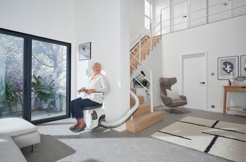 flow x curve stair lift with woman