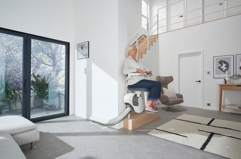 flow x curve stair lift with woman lifting