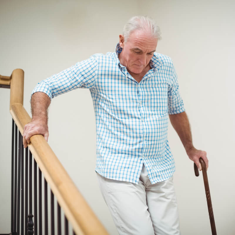 man having trouble decending stairs