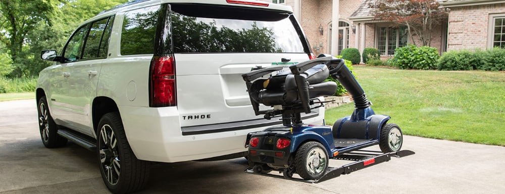 mobility scooter on platform outside back of vehicle