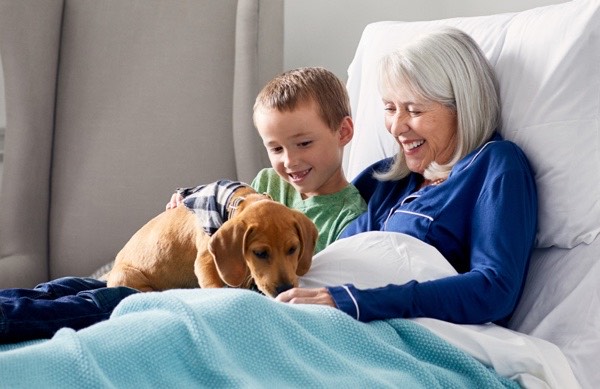 grandma with grandon reading in bed