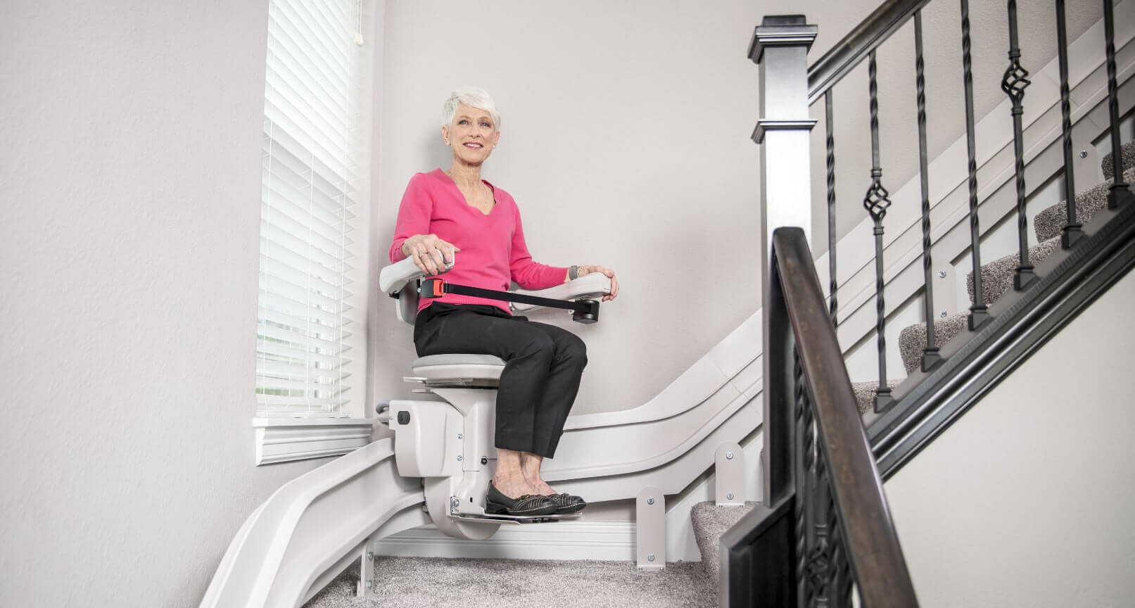 lady riding curved bruno stairlift