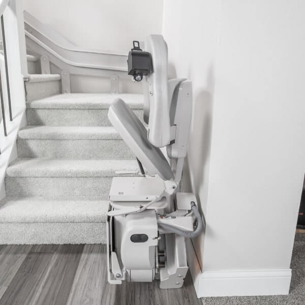 folded curved stair lift at the base of the stairs