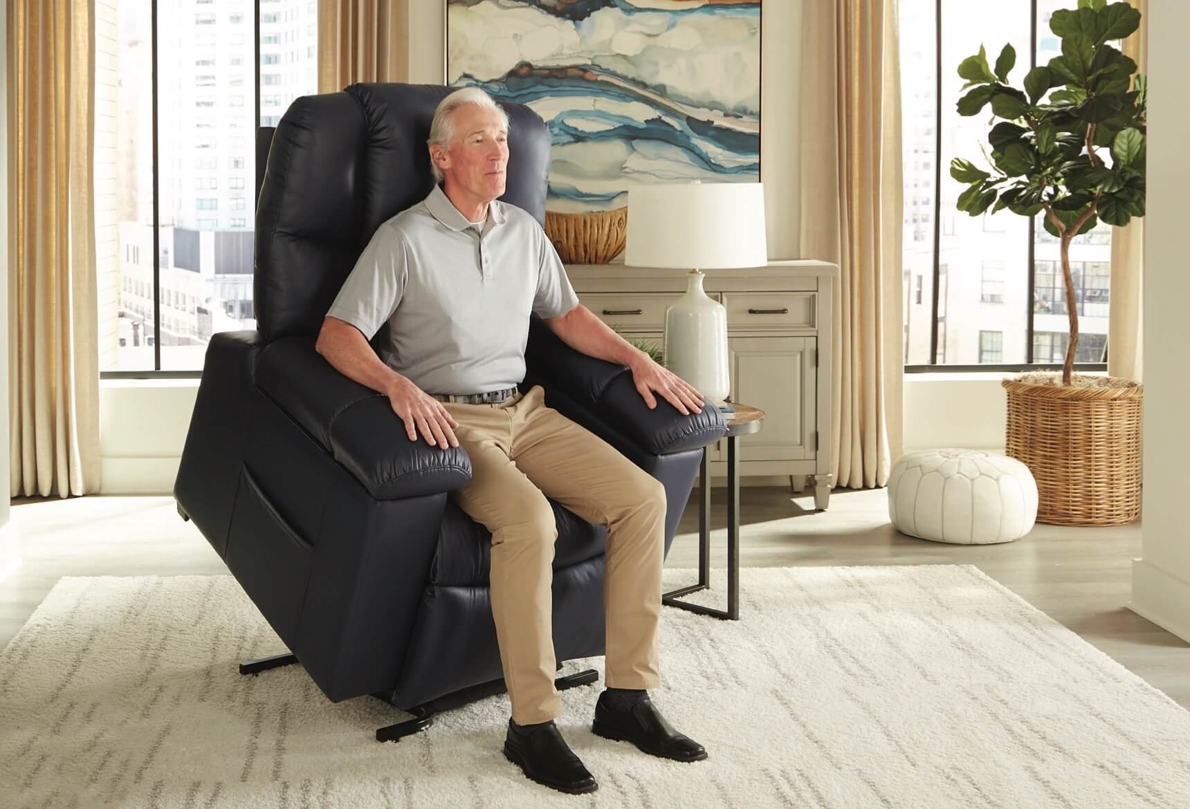 A man standing using a powered lift chair