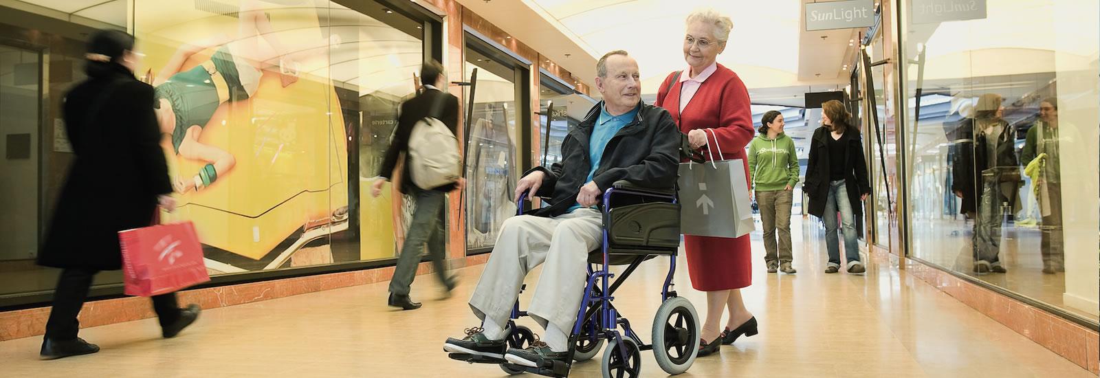 man being pushed while in a transport wheelchair