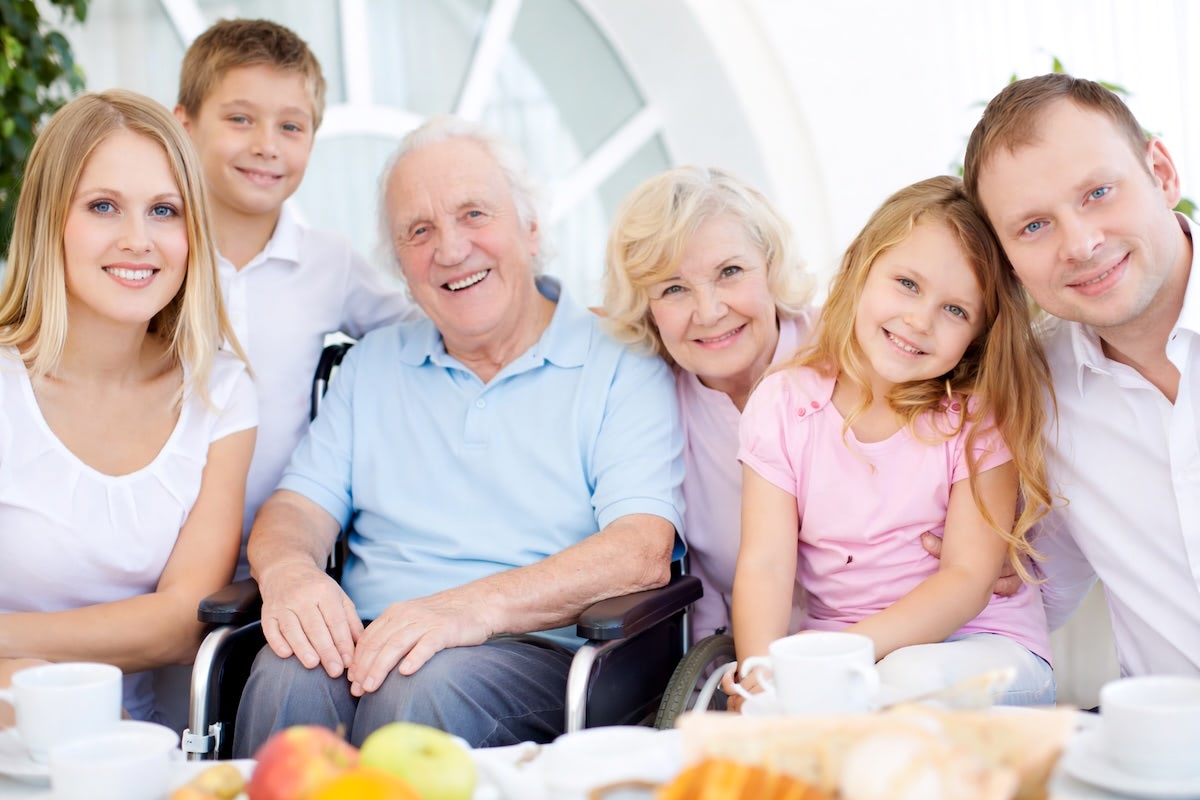 THree generations around granpa in wheelchair