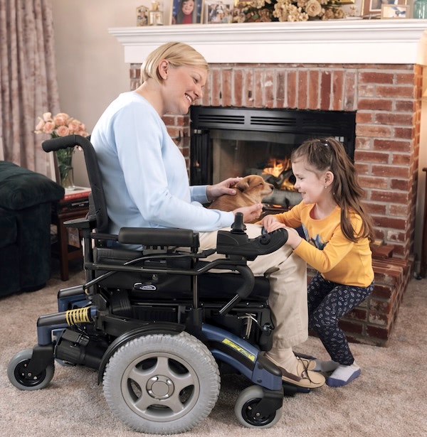mother on Power Wheelchair and daughter at home